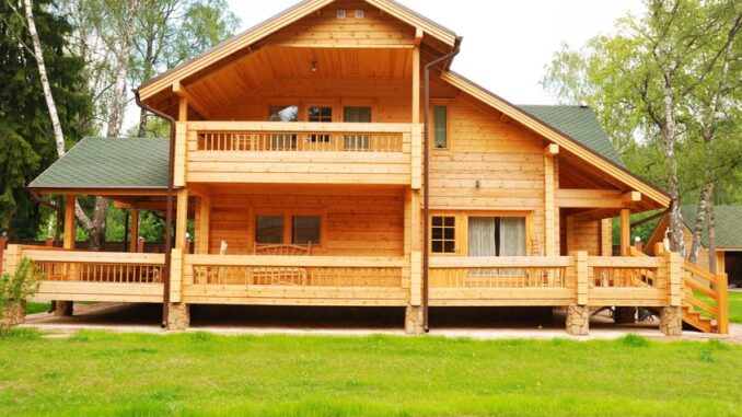 3367917 - wooden house with meadow in front of it